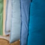 a row of pillows hanging on a wall